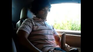 Guy jerking big cock in his car