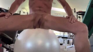 Bouncing on a ball naked at the gym.
