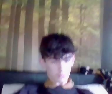 Slender young man with beautiful eyes paints his chest